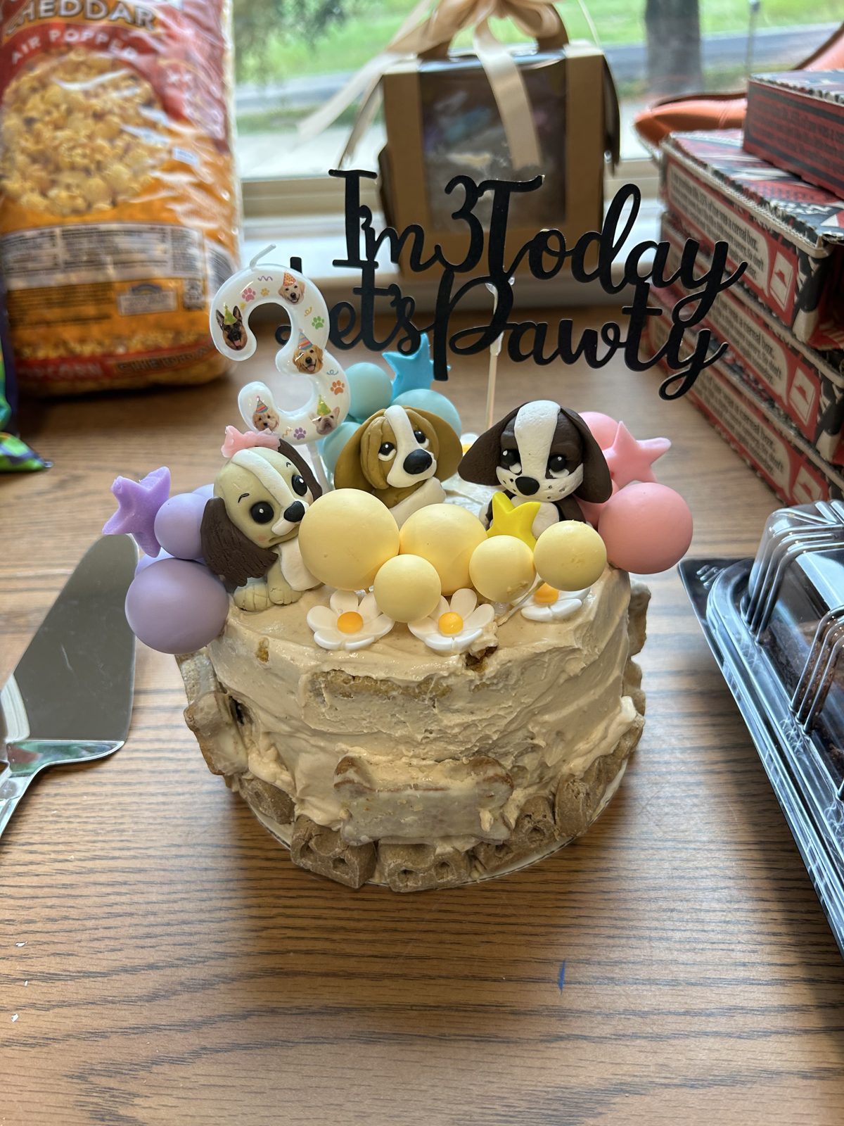 Custom decorated dog birthday cake with fondant puppy toppers