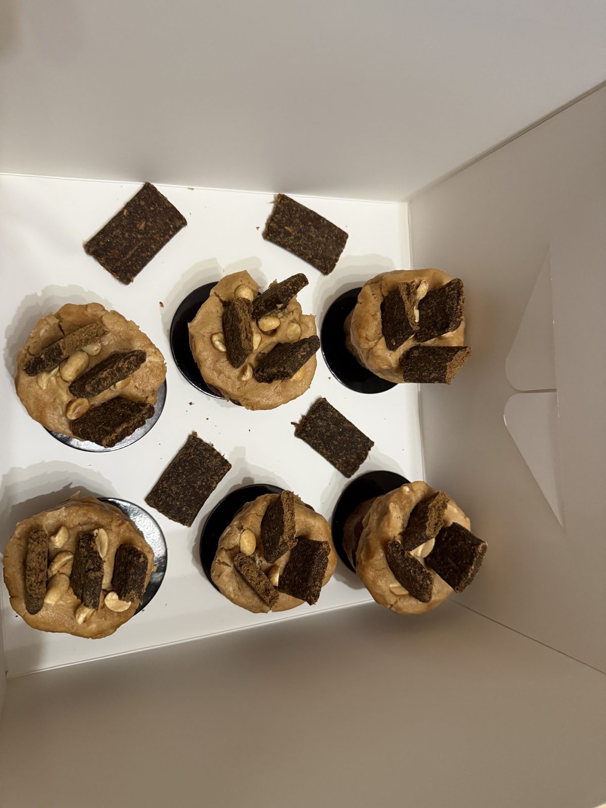 Peanut butter frosted pupcakes topped with a dog treat